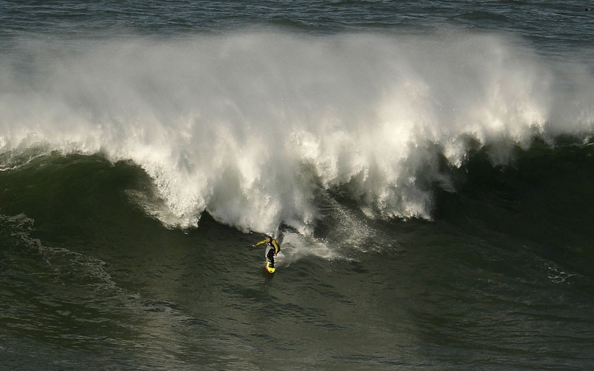 Hawaiian surfer Garrett McNamara on a huge wave in Portugal