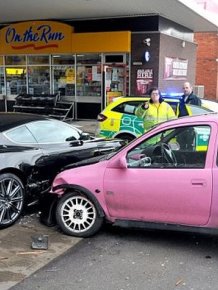 Aston Martin DBS vs Pink Vauxhall Corsa