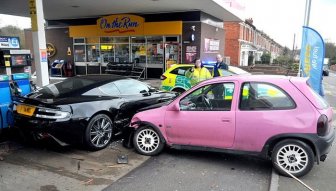 Aston Martin DBS vs Pink Vauxhall Corsa