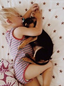 A Toddler and a Puppy Take a Nap
