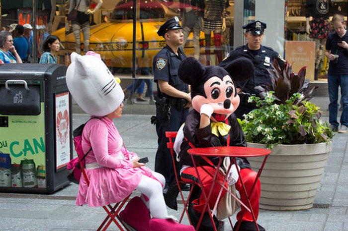 Costumed Characters Hanging Out In Public Doing Everyday Things