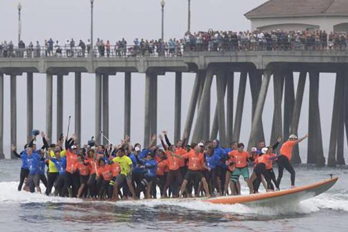 66 Surfers Set A New Guinness Record With A 1,300 Pound Board 
