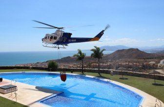 Firefighting Helicopter Refills A Basket With Water From A Swimming Pool