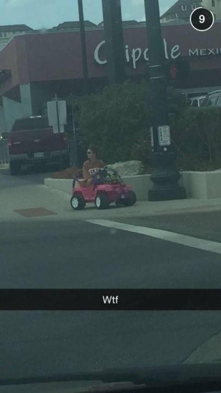 A College Student Rides Around Campus In A Barbie Jeep