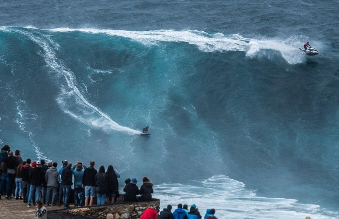 People Watch In Awe As Surfers Ride 100 Foot Waves