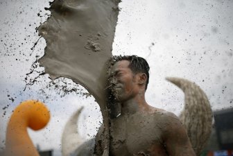 People Let Loose And Get Dirty At The South Korea Mud Festival