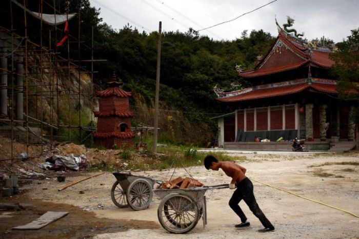 Handyman At Buddhist Temple Constantly Trains On The Job