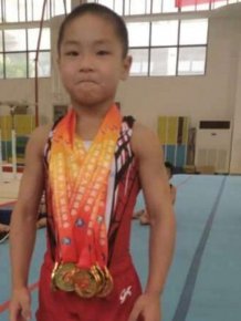 Seven Year Old Chinese Kid Shows Off His Eight Pack After Winning Medals