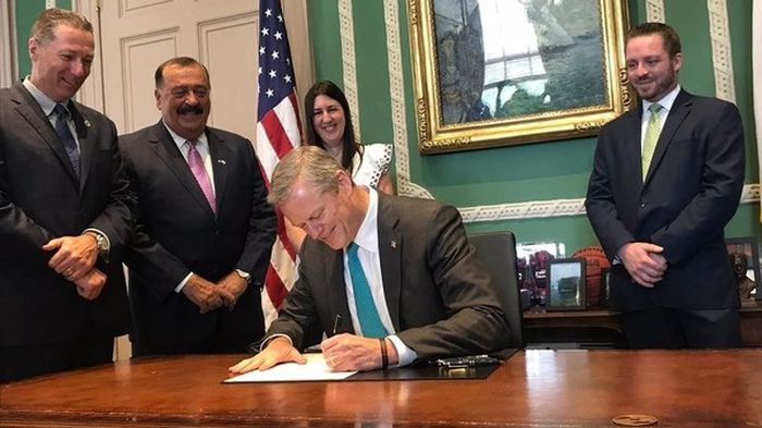 The Governor Of Massachusetts Smiles As He Signs Off On New Law