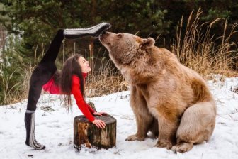 Gymnast Poses With A Brown Bear