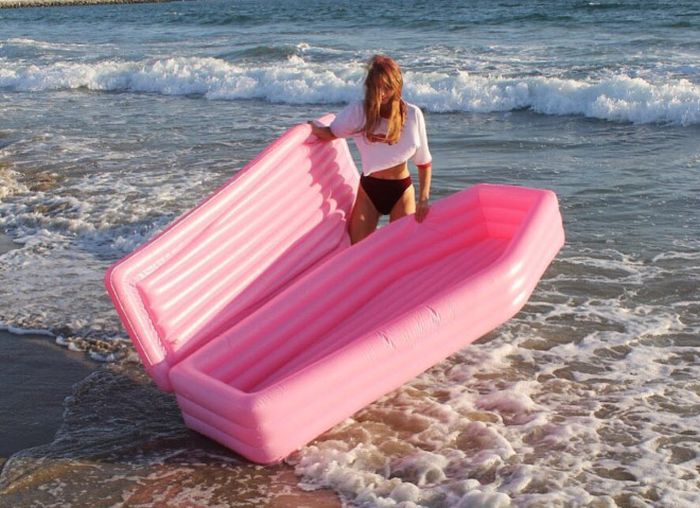A Pink Coffin Pool Float With Lid