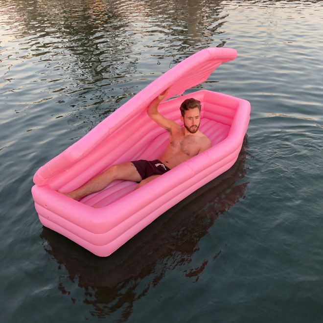 A Pink Coffin Pool Float With Lid