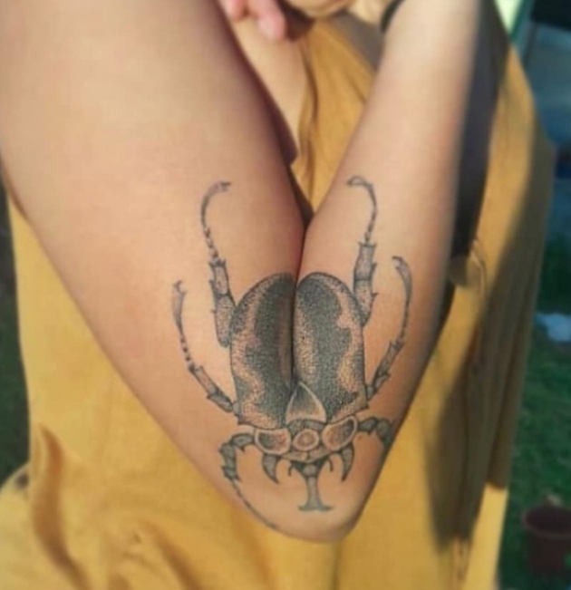 Woman's Beetle Tattoo Spreads Its Wings When She Extends Her Arm