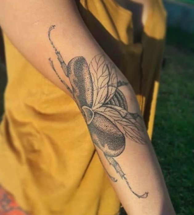 Woman's Beetle Tattoo Spreads Its Wings When She Extends Her Arm