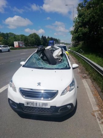 A HGV Wheel Smashes Through A Car Windscreen. The Driver Walks Away