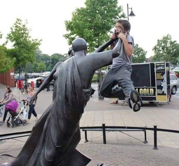 People Having Fun With Sculptures